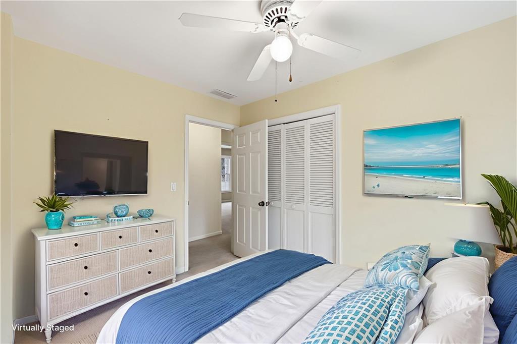6500 Gaines Ferry Road, Unit I4 Flowery Branch, GA 30542 - Photo 24 of 29 a bedroom with a bed and a flat screen tv