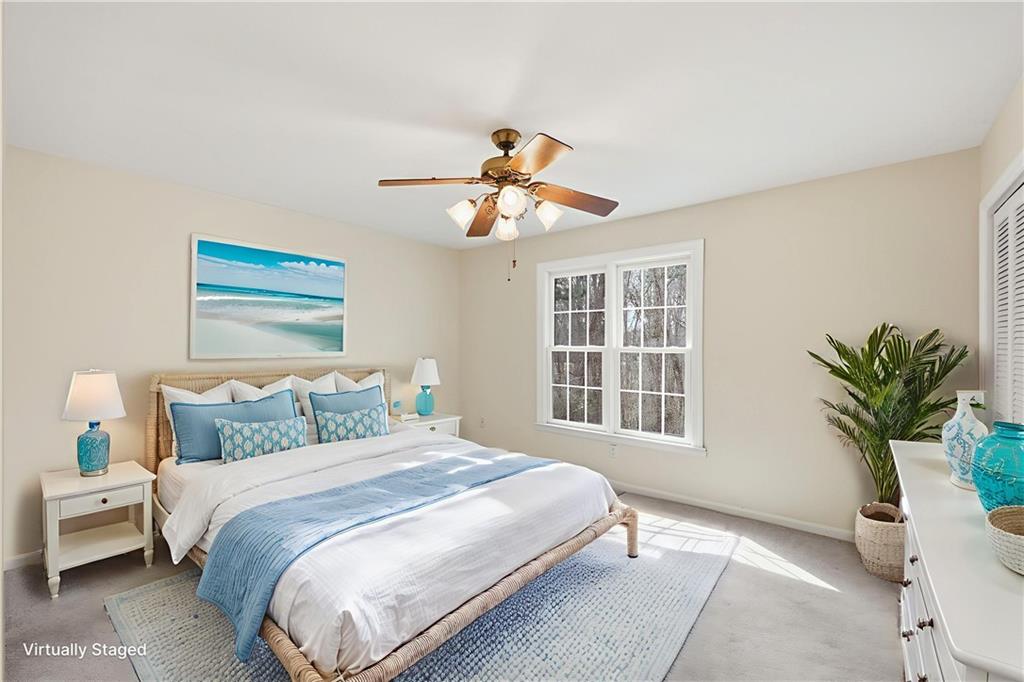 6500 Gaines Ferry Road, Unit I4 Flowery Branch, GA 30542 - Photo 26 of 29 a bedroom with a bed and a potted plant