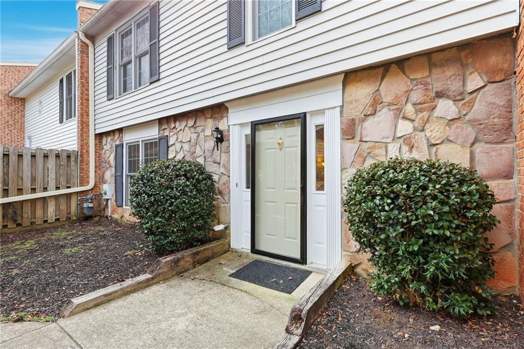 6500 Gaines Ferry Road, Unit I4 Flowery Branch, GA 30542 - Photo 4 of 29 a view of a house with a yard and plants
