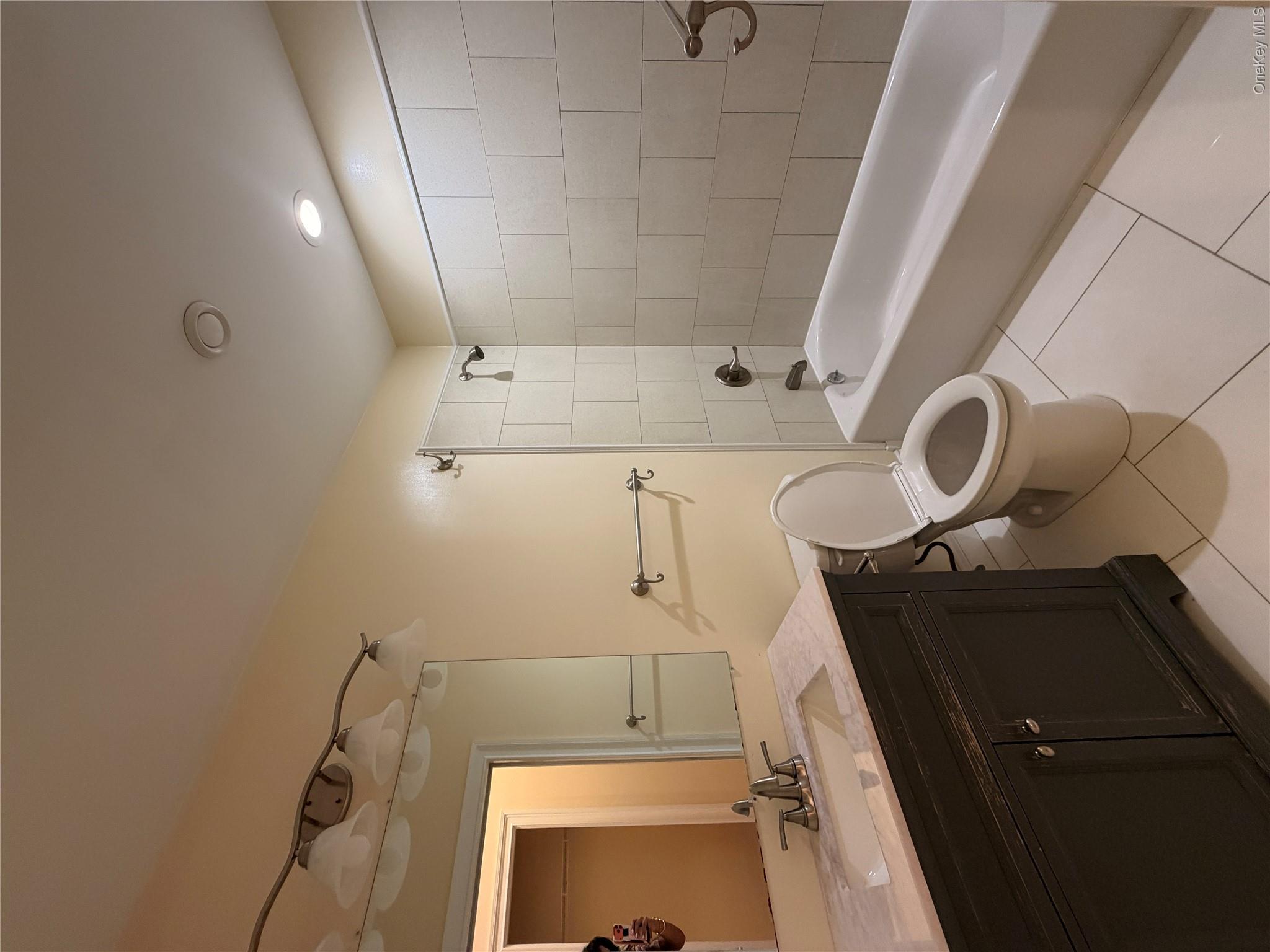 337 Main Street, Unit 3F Poughkeepsie, NY 12601 - Photo 6 of 9 a bathroom with a sink a toilet and shower