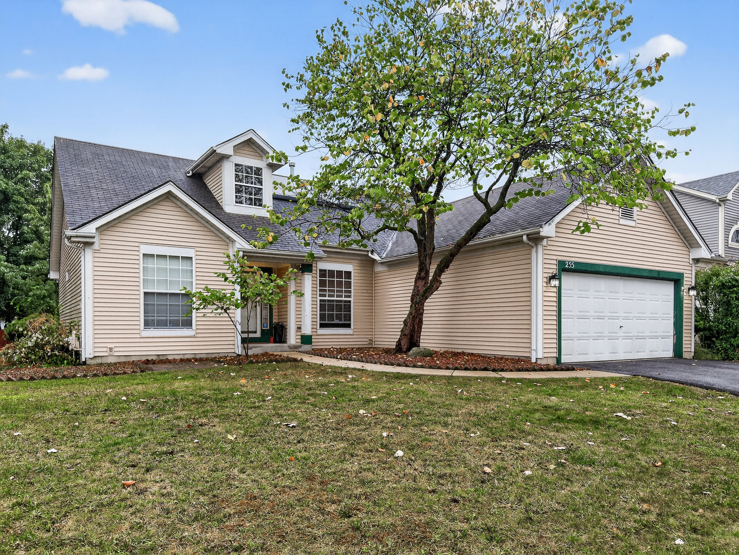 a front view of house with yard and trees