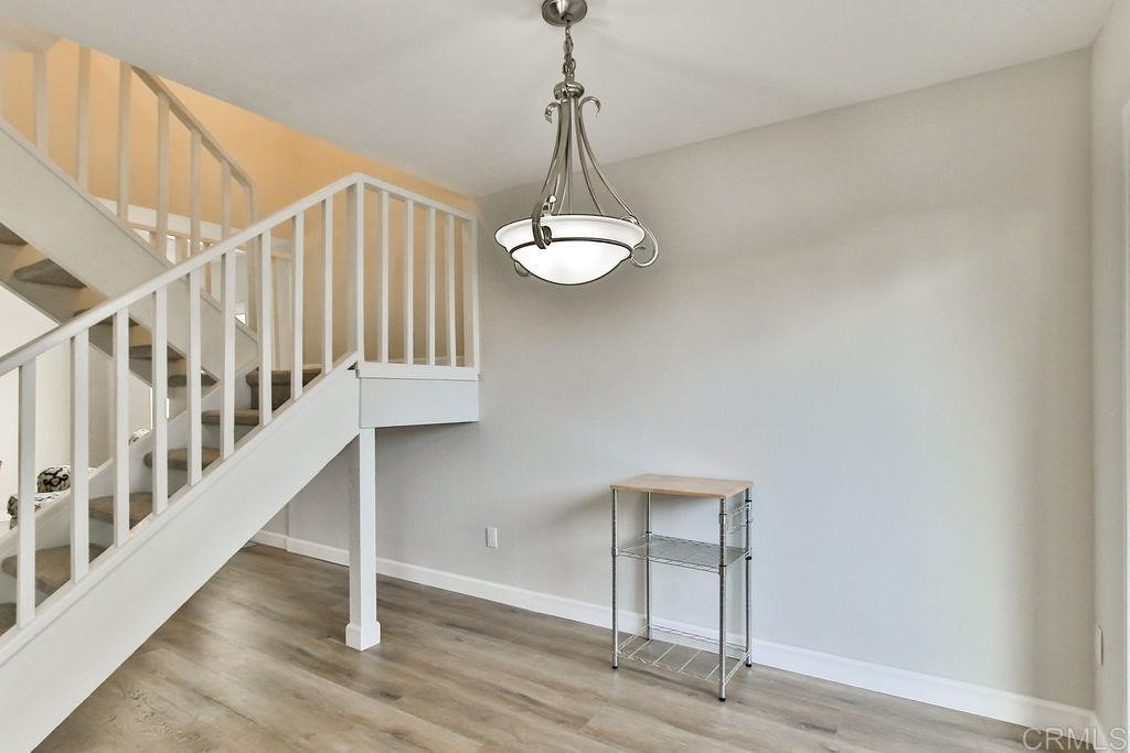 10022 Great Rock Road Santee, CA 92071 - Photo 13 of 32 a view of a hallway with wooden floor and staircase