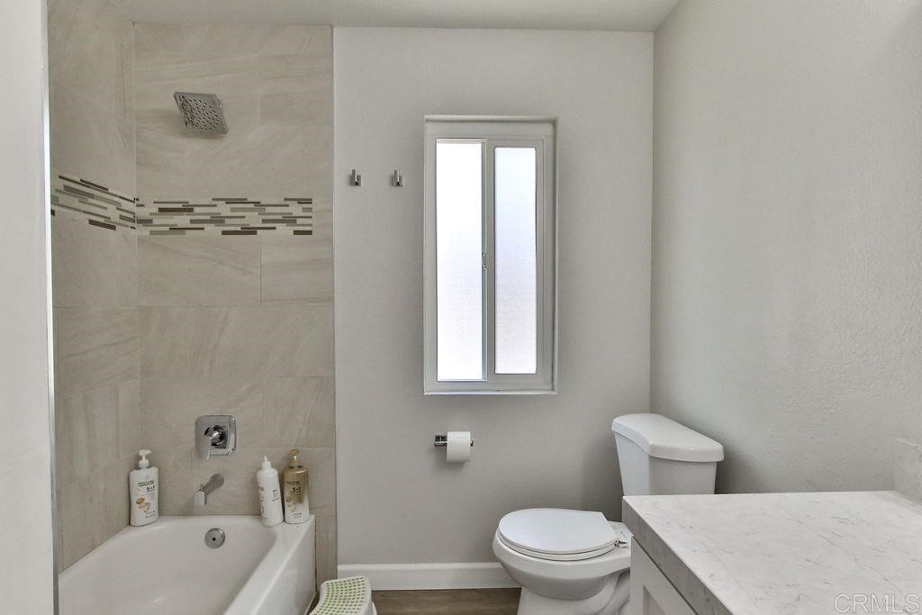 10022 Great Rock Road Santee, CA 92071 - Photo 18 of 32 a bathroom with a toilet a sink and bathtub