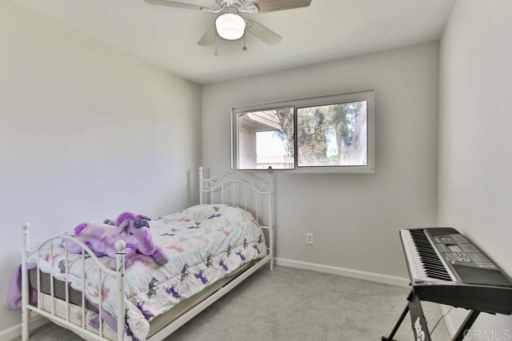 10022 Great Rock Road Santee, CA 92071 - Photo 21 of 32 a bedroom with a bed and window