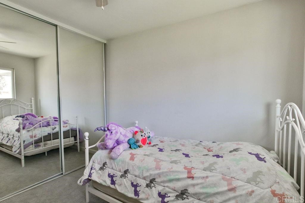 10022 Great Rock Road Santee, CA 92071 - Photo 22 of 32 a bedroom with a bed and window