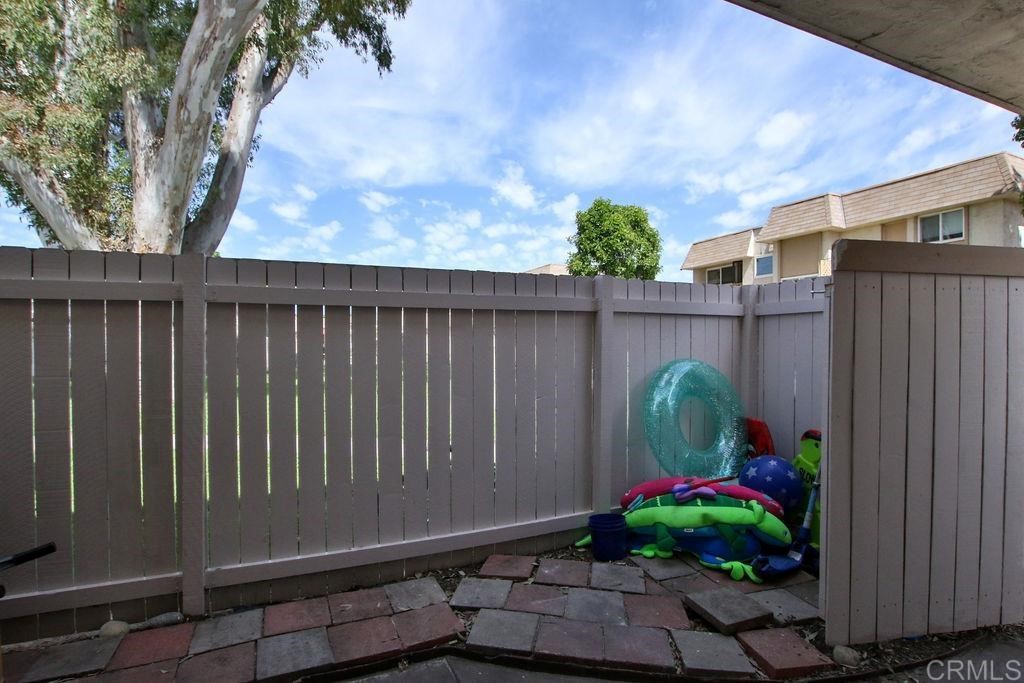 10022 Great Rock Road Santee, CA 92071 - Photo 23 of 32 a backyard with potted plants and a wooden bench