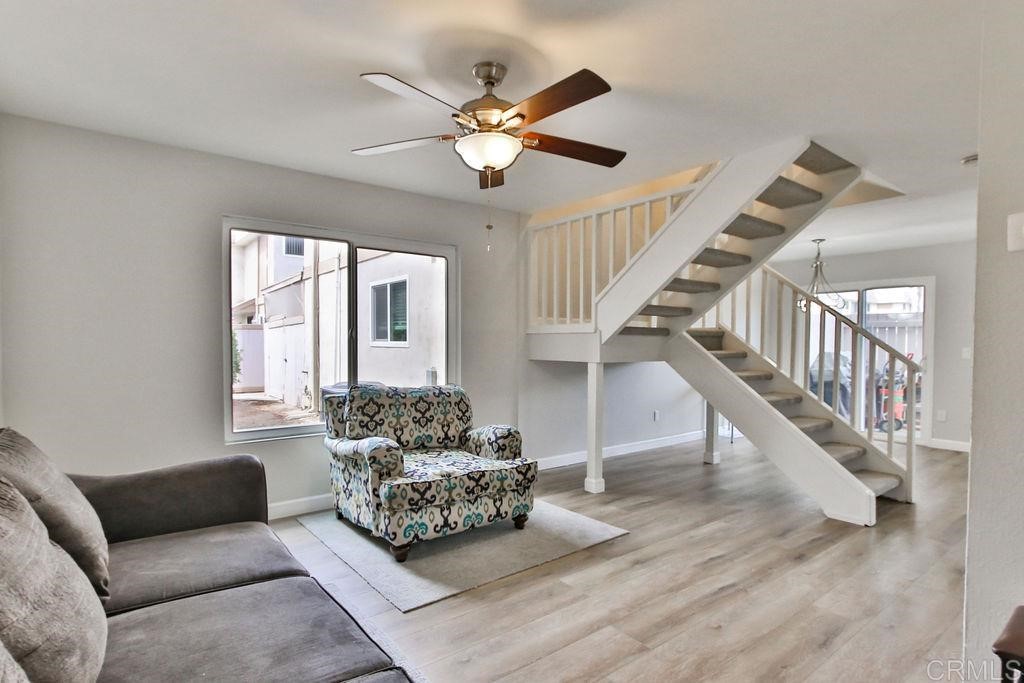 10022 Great Rock Road Santee, CA 92071 - Photo 5 of 32 a living room with furniture ceiling fan and a wooden floor