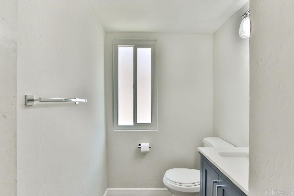 10022 Great Rock Road Santee, CA 92071 - Photo 8 of 32 a white toilet sitting next to a bathroom sink