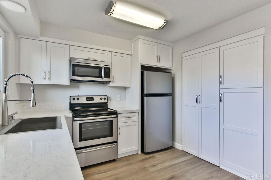 10022 Great Rock Road Santee, CA 92071 - Photo 10 of 32 a kitchen with stainless steel appliances a refrigerator stove and microwave