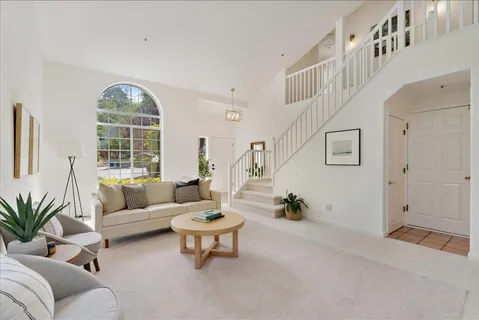 a living room with furniture and a potted plant