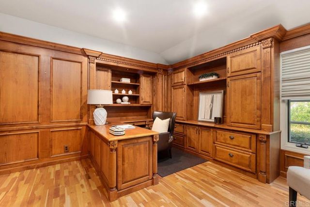 a bathroom with a granite countertop shower a mirror and a sink