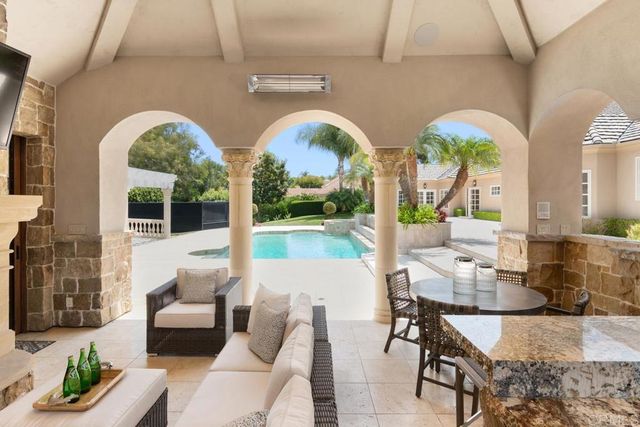 a kitchen with stainless steel appliances granite countertop a sink a stove and a wooden floors