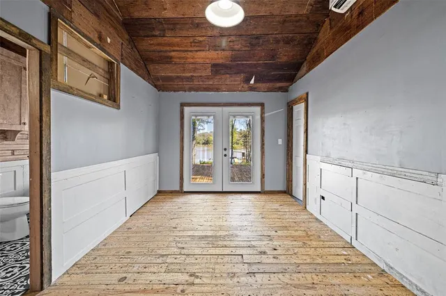 a bedroom with a large bed and a large window
