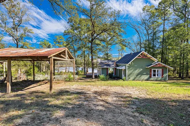 a front view of a house with a yard table and chairs