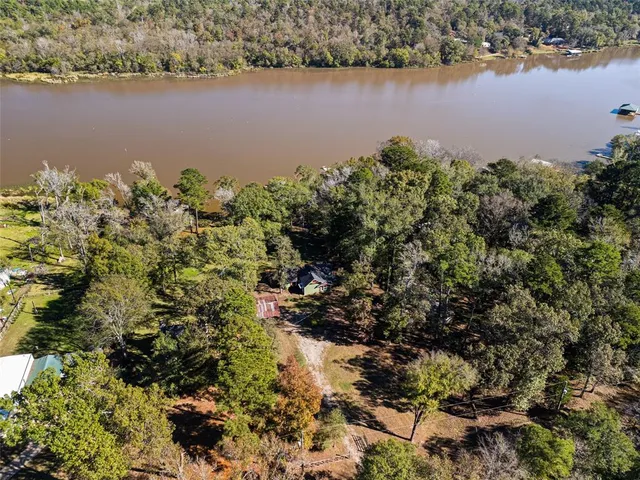 an aerial view of a houses with a lake view