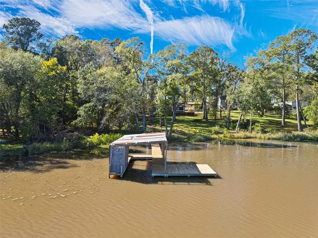 a view of a lake with couches wooden floor and outdoor space