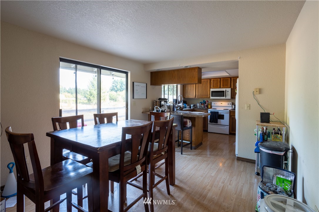 17102 Weaver Lane Southwest Rochester, WA 98579 - Photo 22 of 29 a view of a dining room with furniture and wooden floor