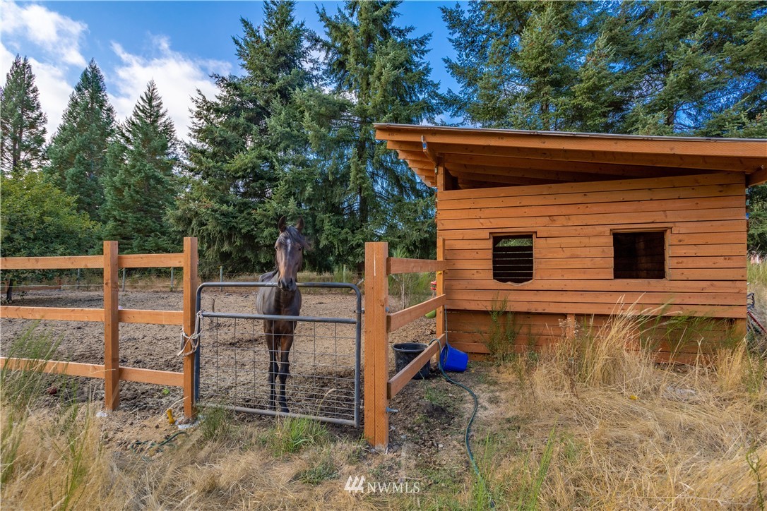 17102 Weaver Lane Southwest Rochester, WA 98579 - Photo 8 of 29 a backyard of a house with wooden floor and fence