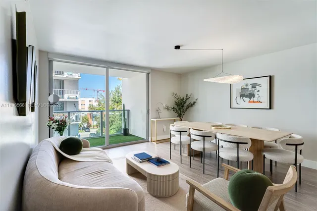a living room with furniture and a floor to ceiling window