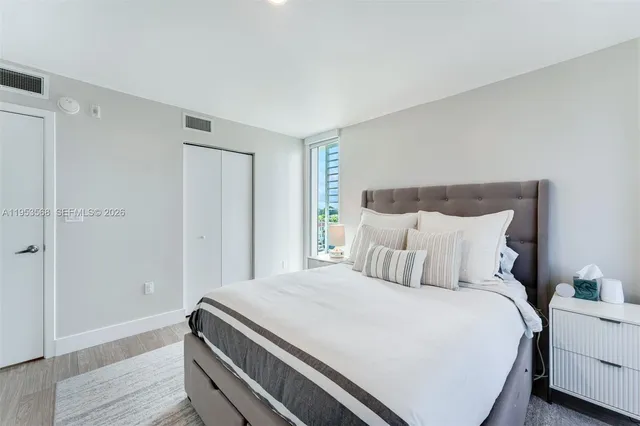 a bedroom with a bed and a night stand