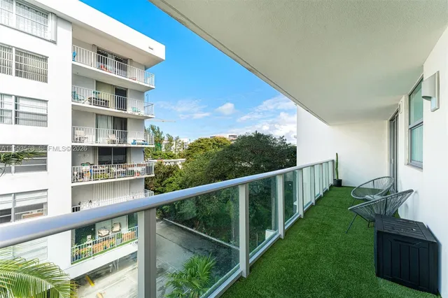a view of a balcony with an outdoor and seating