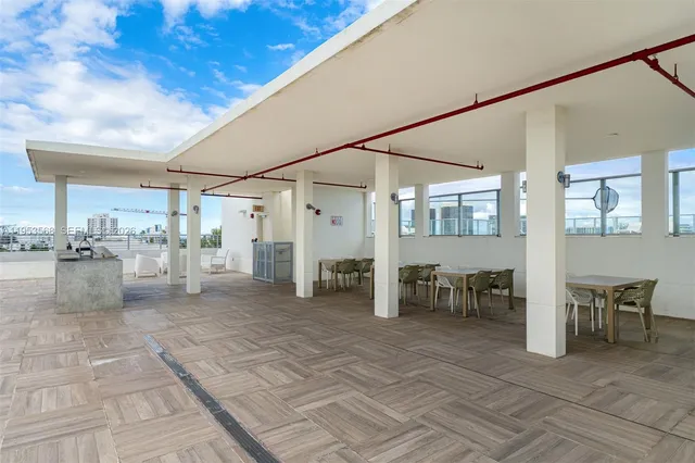 a view of a patio with dining table and chairs