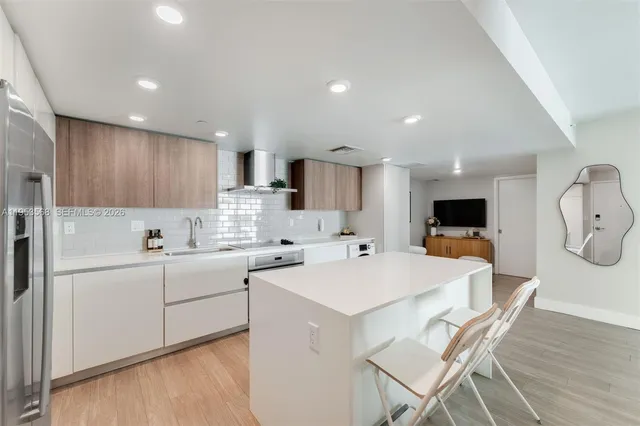 a kitchen with a sink a microwave and cabinets