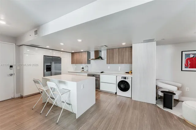 a view of kitchen with table and chairs