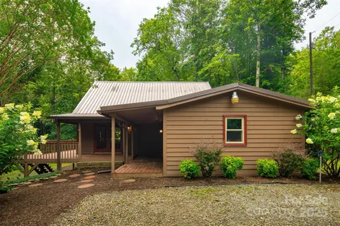 a view of a house with a yard and sitting area