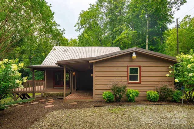 a view of a house with a yard and sitting area
