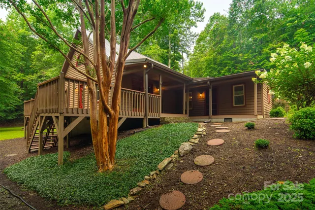 a view of a house with backyard and a tree