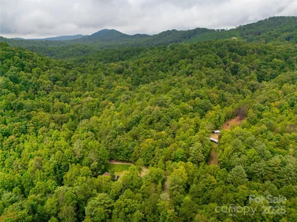 a backyard of a house with a yard and outdoor seating