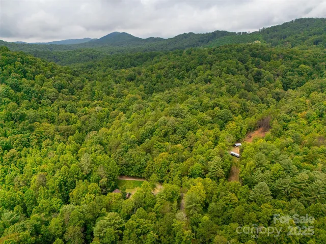 a backyard of a house with a yard and outdoor seating