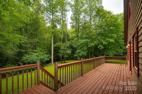 a view of balcony with deck and trees