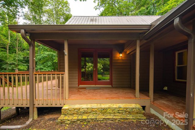 a view of a porch with furniture and a yard