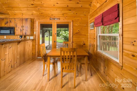 a kitchen with stainless steel appliances granite countertop a stove and a wooden floors