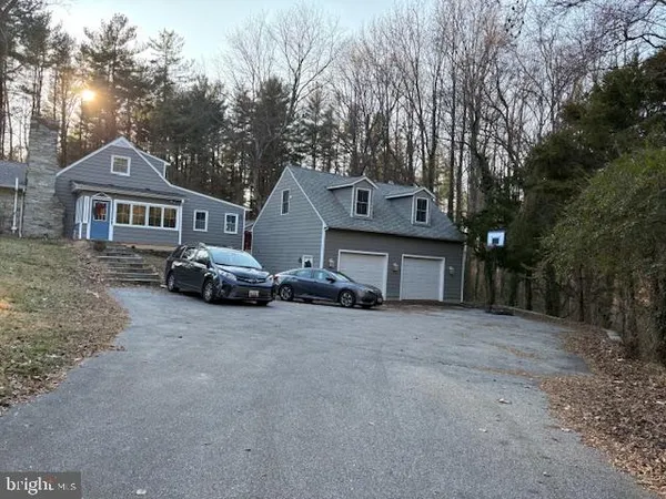 a view of a house with a yard and garage