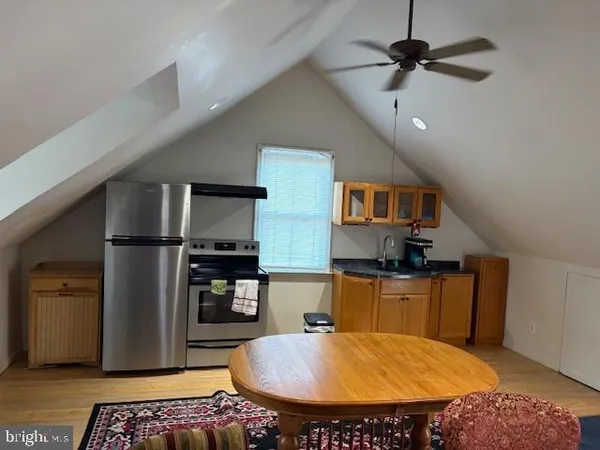 a kitchen with stainless steel appliances granite countertop a sink a stove and a refrigerator