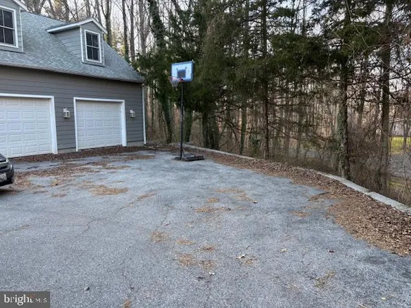 a view of a house with a yard and garage