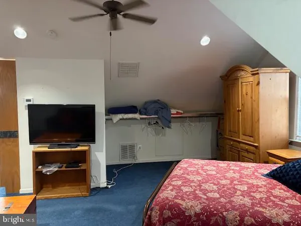 a bedroom with a bed and a flat tv screen