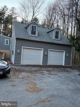 a front view of a house with parking area