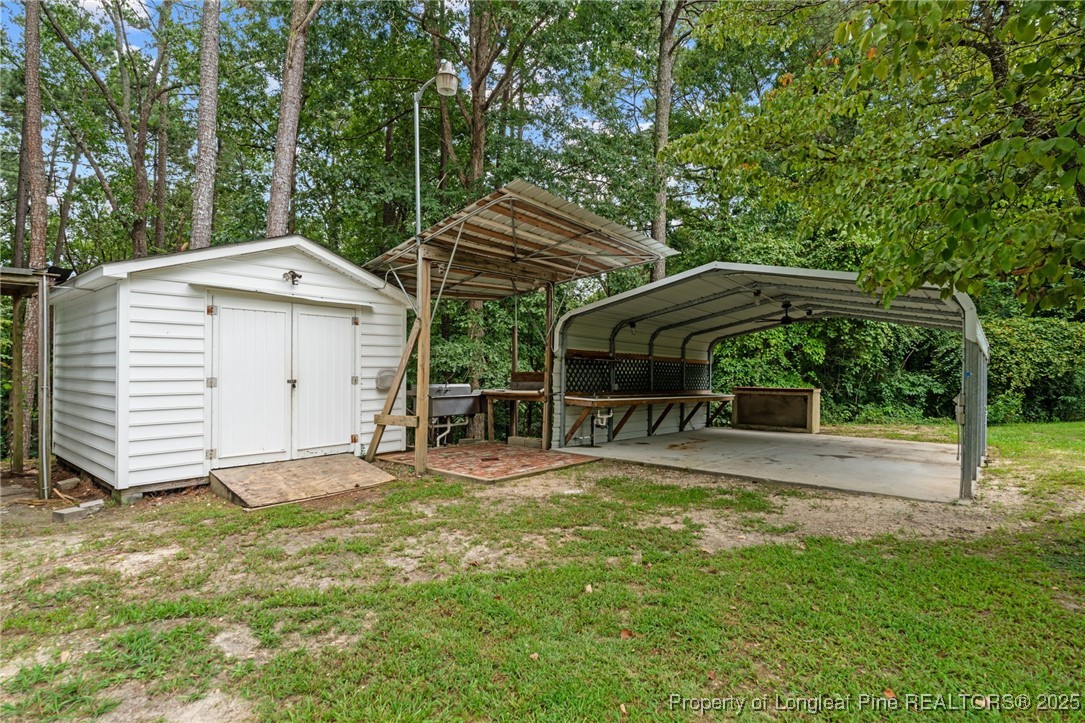 610 Maynard Lake Road Erwin, NC 28339 - Photo 45 of 49 a view of a house with backyard and sitting area