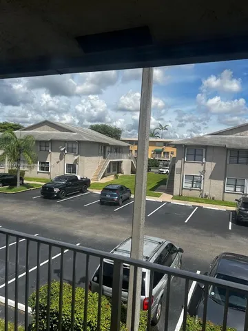 a view of a porch with furniture and backyard