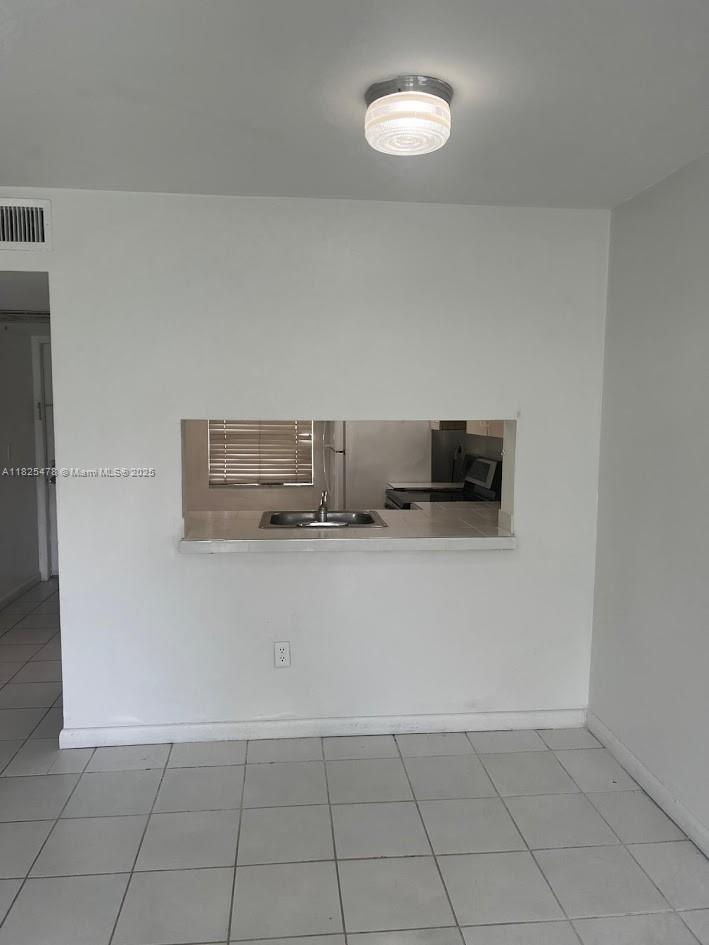 7670 Southwest 152nd Avenue, Unit 1202 Miami, FL 33193 - Photo 4 of 9 a view of kitchen and an empty room