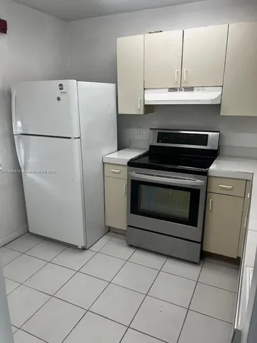 a kitchen with cabinets and appliances