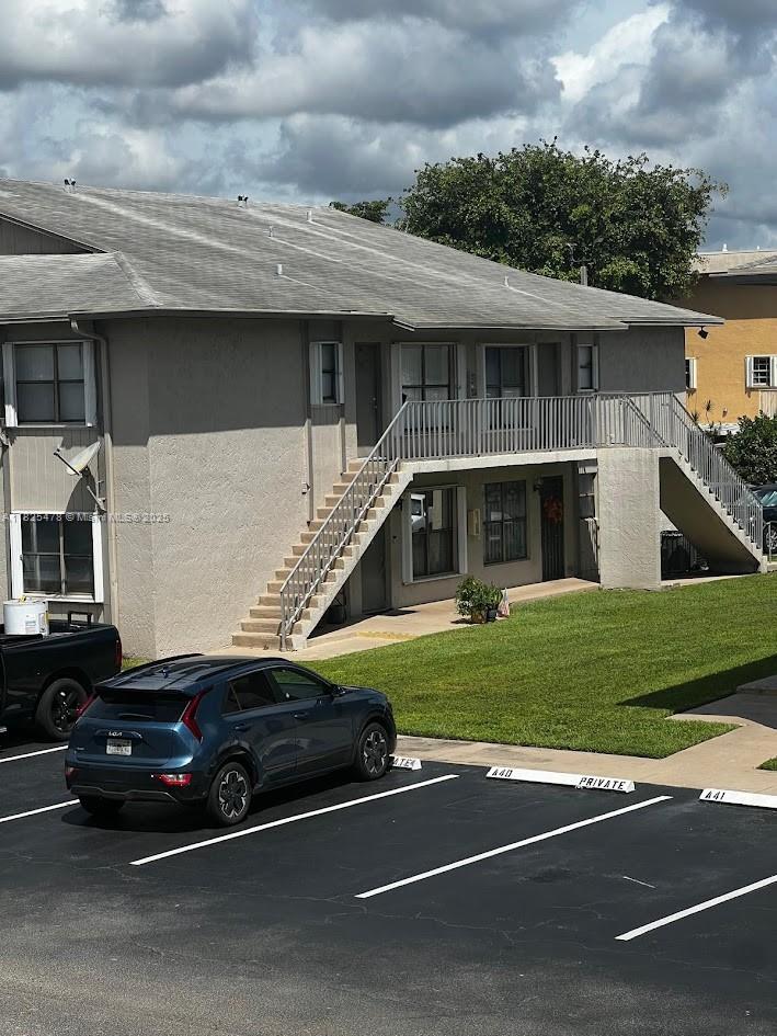 7670 Southwest 152nd Avenue, Unit 1202 Miami, FL 33193 - Photo 9 of 9 a car parked in front of a house
