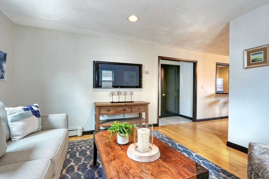 12 Jenkins Street Boston, MA 02127 - Photo 1 of 16 a living room with furniture and a wooden floor