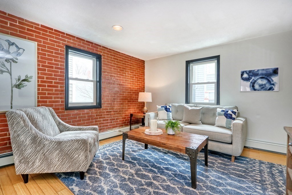 12 Jenkins Street Boston, MA 02127 - Photo 2 of 16 a living room with furniture a rug and a window