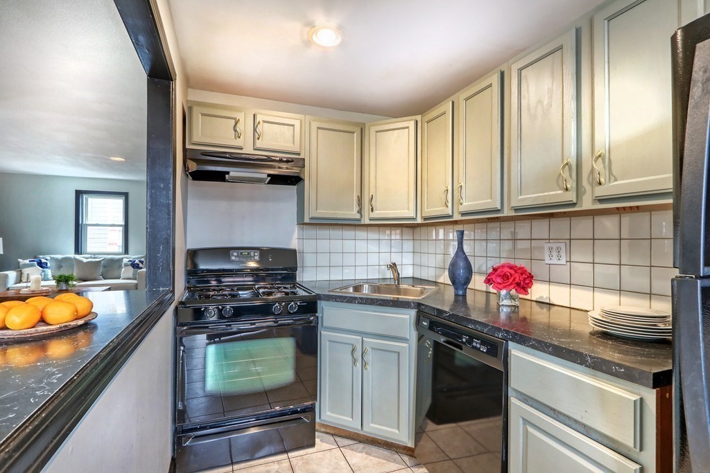 12 Jenkins Street Boston, MA 02127 - Photo 5 of 16 a kitchen with stainless steel appliances granite countertop a stove sink and cabinets