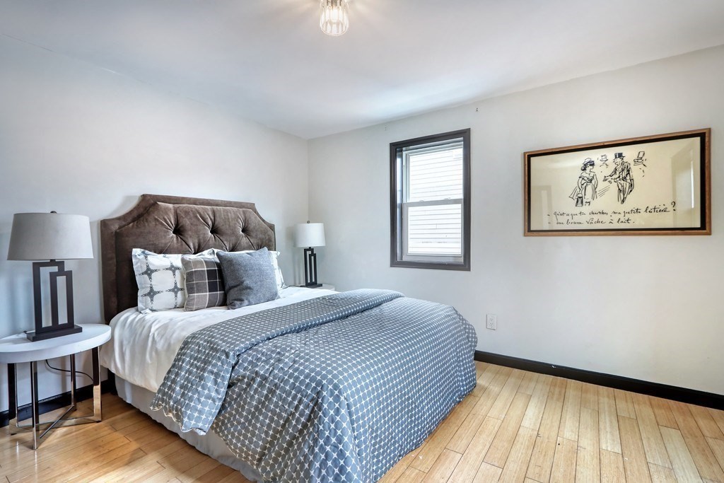 12 Jenkins Street Boston, MA 02127 - Photo 7 of 16 a bed room with a bed and a painting on the wall